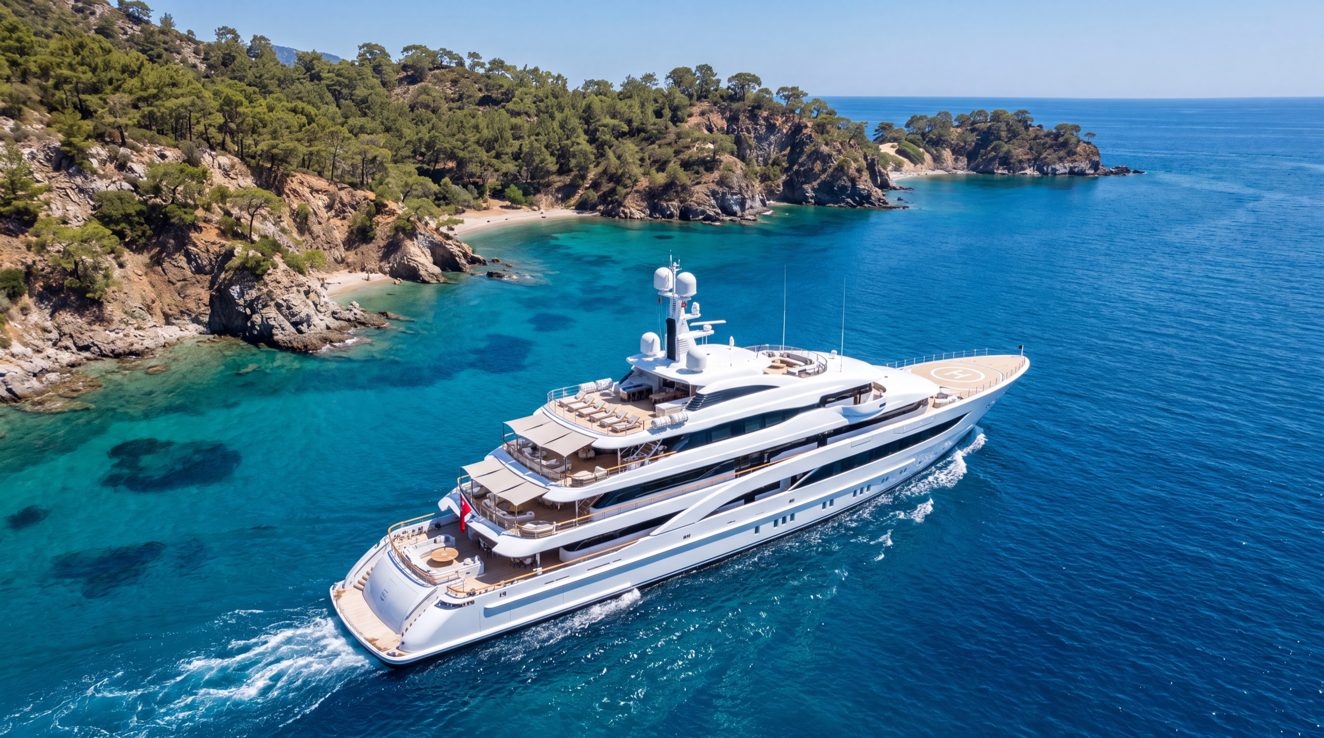 A large motor superyacht cruising along the turquoise Turkish coastline
