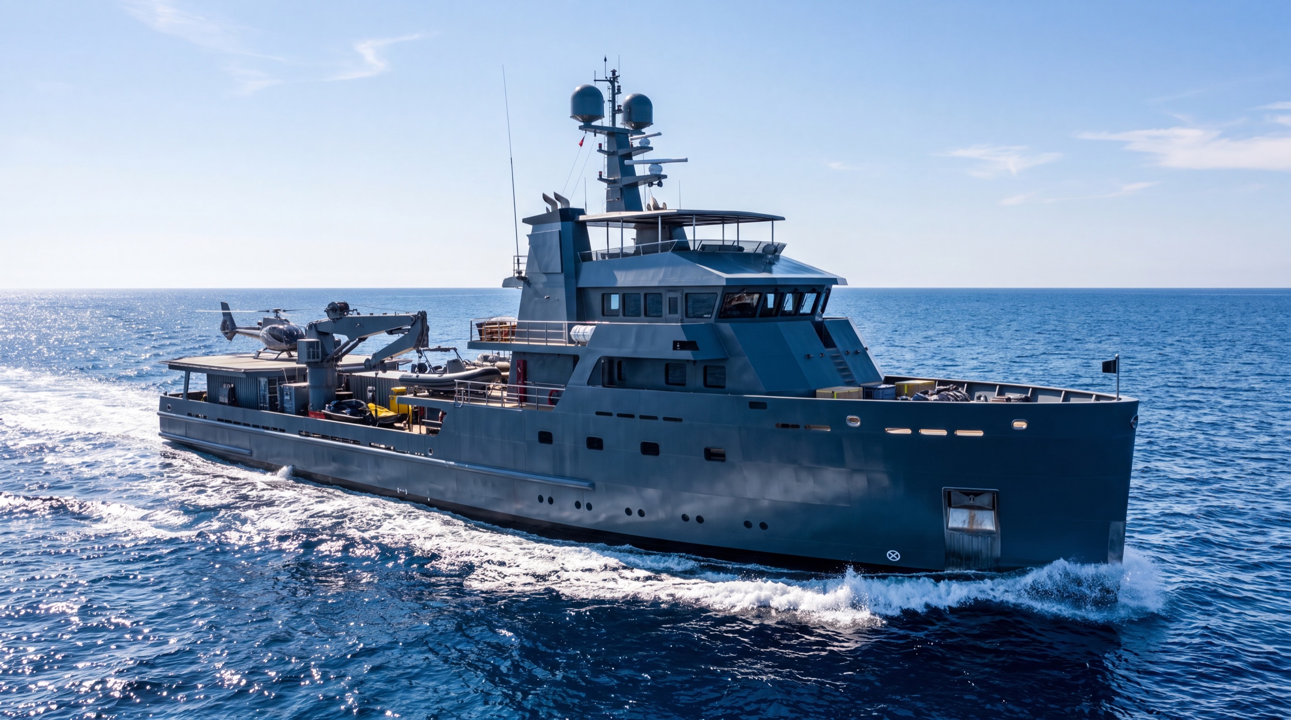 A rugged explorer yacht with a dark hull cruising open water